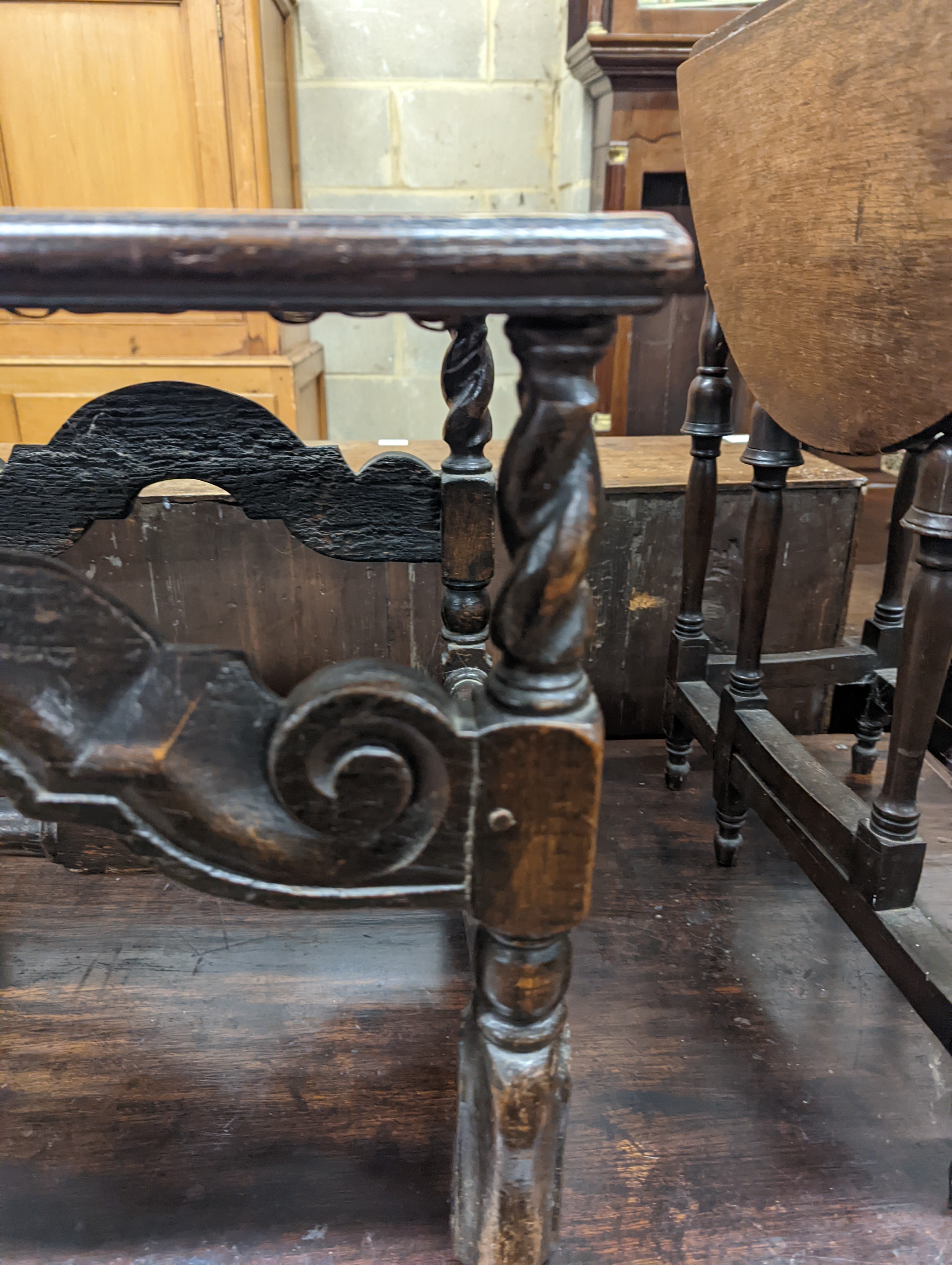 A 17th century style carved oak stool, with caned seat and H stretcher, width 47cm, depth 46cm, height 42cm